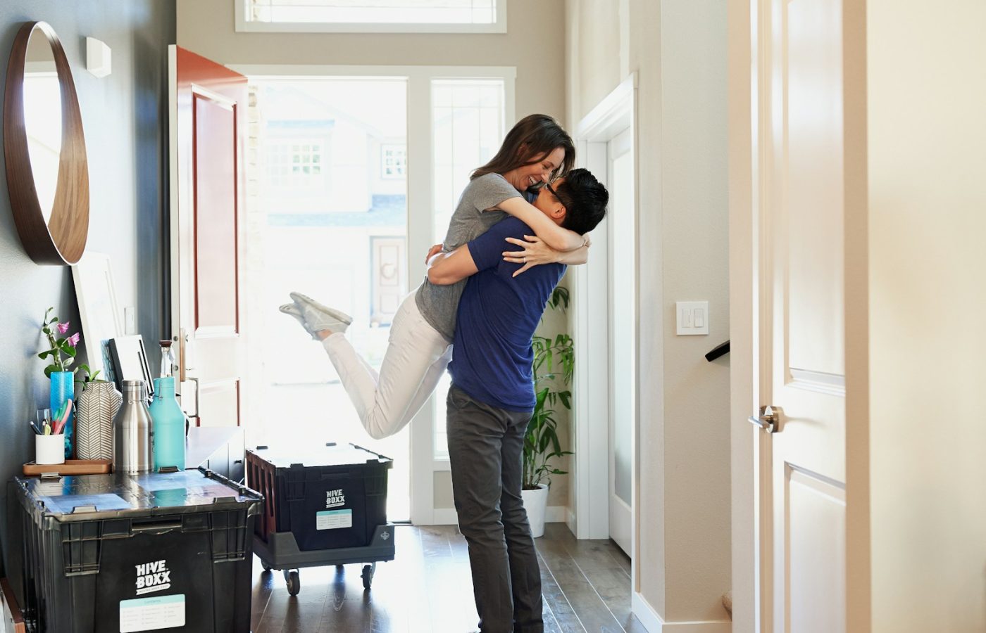 woman in gray long sleeve shirt and gray pants standing beside white wooden door
